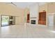 Bright living room featuring tile floors, a fireplace, and sliding doors to the pool area at 2931 Sunbittern Ct, Windermere, FL 34786