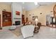 Bright living room featuring a white brick fireplace and spiral staircase at 2931 Sunbittern Ct, Windermere, FL 34786