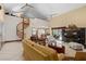 Open-concept living area with a spiral staircase, bar, and expansive windows overlooking the pool, great for entertaining at 2931 Sunbittern Ct, Windermere, FL 34786