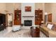Cozy living room with a white brick fireplace, built-in bookshelves, and ample natural light at 2931 Sunbittern Ct, Windermere, FL 34786