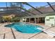 Relaxing screened-in pool with spa and diving board, complete with outdoor kitchen at 2931 Sunbittern Ct, Windermere, FL 34786