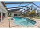 View of the pool with spa and sun-shelf, overlooking the backyard at 2931 Sunbittern Ct, Windermere, FL 34786