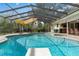 Enclosed pool area with covered seating and lush green backyard at 2931 Sunbittern Ct, Windermere, FL 34786