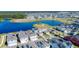 Expansive aerial shot showcases the community featuring modern homes, a large pond, and lush greenery at 2970 Scout St, St Cloud, FL 34771