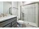 Bathroom showcasing a glass-enclosed shower, granite vanity, and modern fixtures at 2970 Scout St, St Cloud, FL 34771