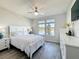 Bright bedroom with hardwood floors, ceiling fan and a picturesque lake view from the window at 2970 Scout St, St Cloud, FL 34771