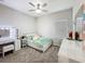 Bedroom features a twin bed, vanity, ceiling fan and large window for ample light at 2970 Scout St, St Cloud, FL 34771
