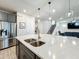 Open-concept kitchen boasts a quartz countertop island and stainless steel appliances at 2970 Scout St, St Cloud, FL 34771
