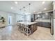 Spacious kitchen featuring a large island, pendant lighting, and stainless steel appliances at 2970 Scout St, St Cloud, FL 34771