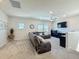 Large living room with reclining couches, carpet flooring, ceiling fan and many windows for ample light at 2970 Scout St, St Cloud, FL 34771