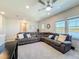 Large living room featuring a reclining sectional couch, carpet flooring, and a view of the lake at 2970 Scout St, St Cloud, FL 34771