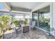 Charming outdoor seating area with gray chairs, a table, and access through sliding glass doors at 2970 Scout St, St Cloud, FL 34771