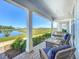 Inviting porch featuring cushioned wicker furniture with a scenic view of the community pond at 2970 Scout St, St Cloud, FL 34771