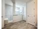 Modern bathroom featuring a tiled shower with glass door and built-in bench at 2970 Scout St, St Cloud, FL 34771