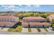 An aerial view of multi-Gathering townhomes featuring barrel tile roofing and attached garages at 3127 Via Otero Dr, Kissimmee, FL 34744