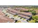 An aerial view of townhomes featuring barrel tile roofing, street parking, and mature landscaping at 3127 Via Otero Dr, Kissimmee, FL 34744