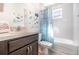 Bright bathroom features a large vanity, tub/shower with mermaid-themed shower curtain, and fun underwater decals at 3127 Via Otero Dr, Kissimmee, FL 34744