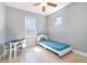 Bright bedroom with gray walls, wood-look floors, and ample natural light at 3127 Via Otero Dr, Kissimmee, FL 34744