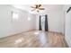 This bedroom features wood-look floors, a ceiling fan, and ample natural light at 3127 Via Otero Dr, Kissimmee, FL 34744