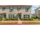 Well-maintained townhome featuring updated windows, manicured shrubs, and a vibrant front exterior at 3127 Via Otero Dr, Kissimmee, FL 34744