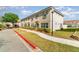 Street view of the exterior of townhomes boasting neutral stucco exteriors and tiled roofs at 3127 Via Otero Dr, Kissimmee, FL 34744