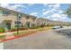 Street view of townhomes with lush landscaping, tile roofs, and neutral exteriors at 3127 Via Otero Dr, Kissimmee, FL 34744