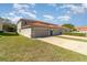 Exterior view of garages with ample parking spaces and green spaces at 3127 Via Otero Dr, Kissimmee, FL 34744