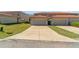 Exterior view of garages with ample parking spaces and green spaces at 3127 Via Otero Dr, Kissimmee, FL 34744