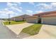 Exterior view of garages with ample parking spaces and green spaces at 3127 Via Otero Dr, Kissimmee, FL 34744