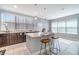 Bright kitchen boasts granite counters, dark wood cabinets, and center island with bar seating at 3127 Via Otero Dr, Kissimmee, FL 34744