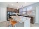 Bright kitchen island with granite countertops, stylish pendant lighting, and barstool seating at 3127 Via Otero Dr, Kissimmee, FL 34744