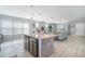 Open concept kitchen with granite island overlooks living area and offers seamless entertaining at 3127 Via Otero Dr, Kissimmee, FL 34744