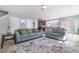 Comfortable living room featuring plush sofas, an area rug, and an open layout connected to the kitchen at 3127 Via Otero Dr, Kissimmee, FL 34744