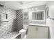 Stylishly renovated bathroom features modern vanity and sink, tiled walk-in shower with sleek gray brick-patterned tile at 320 Black Oak Ct # 102, Altamonte Springs, FL 32701