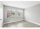 The bedroom includes wood-look floors and natural light from two windows at 320 Black Oak Ct # 102, Altamonte Springs, FL 32701