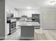 Well-equipped kitchen with stainless steel appliances, white cabinets, granite countertops and breakfast bar is perfect for cooking at 320 Black Oak Ct # 102, Altamonte Springs, FL 32701