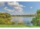 Scenic lake view with lush greenery and clear blue sky, offering serene natural beauty at 320 Black Oak Ct # 102, Altamonte Springs, FL 32701