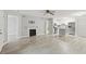 Bright open living space with fireplace, light wood floors, ceiling fan and combined kitchen area create a cozy atmosphere at 320 Black Oak Ct # 102, Altamonte Springs, FL 32701