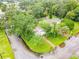 Aerial view of a charming home with a well-kept lawn and walkway, surrounded by mature trees at 322 And 322 1/2 S Maple Ave, Sanford, FL 32771