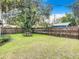 A large backyard is surrounded by a wood fence and mature trees at 322 And 322 1/2 S Maple Ave, Sanford, FL 32771