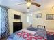 Cozy bedroom with a colorful quilt, a ceiling fan, television and closet at 322 And 322 1/2 S Maple Ave, Sanford, FL 32771