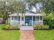 Charming cottage-style home with a brick walkway, inviting porch, and lush landscaping enhances its curb appeal at 322 And 322 1/2 S Maple Ave, Sanford, FL 32771