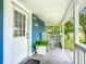 Inviting front porch with white rocking chairs, a potted plant, and a view of the neighborhood at 322 And 322 1/2 S Maple Ave, Sanford, FL 32771