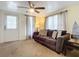 Inviting living room featuring a plush brown sofa, decorative pillows, and a ceiling fan for comfort at 322 And 322 1/2 S Maple Ave, Sanford, FL 32771