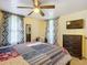 Cozy bedroom with a ceiling fan, a warm color palette, and a comfortable bed at 322 And 322 1/2 S Maple Ave, Sanford, FL 32771