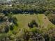 Aerial view of expansive acreage dotted with trees and buildings, offering privacy and potential at 372 Carpenter Ave, Osteen, FL 32764