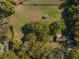 Bird's-eye view of the property featuring a well-maintained lawn, mature trees, and a charming home with a serene pond at 372 Carpenter Ave, Osteen, FL 32764