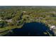 Aerial view of a waterfront acreage bordered in red, showcasing the land's position by a beautiful lake surrounded by lush trees at 372 Carpenter Ave, Osteen, FL 32764