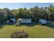 Aerial photo showing various outbuildings on a grassy lot that include two shipping containers and an open vehicle storage area at 372 Carpenter Ave, Osteen, FL 32764