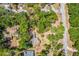 Aerial view showcases the home nestled among trees with a sprawling yard, offering a sense of privacy and space at 450 Cassady St, Umatilla, FL 32784